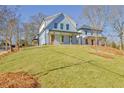 Charming two-story home featuring a welcoming front porch and a well-maintained front yard at 3165 Old Jonesboro Rd, Hapeville, GA 30354