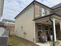 Side of home featuring outdoor seating area with egg chairs on back porch at 7266 Gladstone Cir, Lithonia, GA 30038