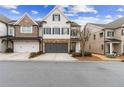 Beautiful townhome exterior featuring stone accents, a gray garage door, and a paved driveway at 569 Stone Field Nw Run, Marietta, GA 30060