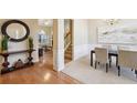 Elegant dining area with hardwood floors, complemented by neutral walls and stylish furniture at 1135 Chandler Ridge Dr, Lawrenceville, GA 30045