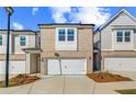 Beautiful townhome with a one-car garage and brick accents at 312 Shine Dr, Stockbridge, GA 30281