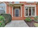 Charming brick home with a welcoming front porch and neatly trimmed landscaping at 5990 Somerset Ct, Suwanee, GA 30024