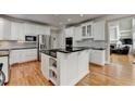 Spacious kitchen features white cabinetry, stainless steel appliances, black countertops, and a large island at 5990 Somerset Ct, Suwanee, GA 30024