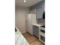 Bright kitchen features updated appliances, marbled countertops, and wood-look floors at 145 15Th St # Apt 1023, Atlanta, GA 30309