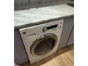Convenient laundry room with marbled countertops and modern washer at 145 15Th St # Apt 1023, Atlanta, GA 30309