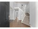 Bright foyer showcasing hardwood floors and an elegant staircase at 4391 Chatuge Dr, Buford, GA 30519