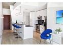 Well-lit kitchen with stainless steel appliances, breakfast bar, and contemporary design at 860 Peachtree Ne St # 1008, Atlanta, GA 30308