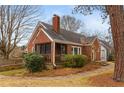 A charming brick house with a cozy screened-in porch and well-manicured landscaping at 1721 Clifton Se Way, Atlanta, GA 30316