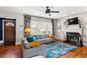 Cozy living room with hardwood floors, fireplace, ceiling fan, and plenty of natural light at 1721 Clifton Se Way, Atlanta, GA 30316