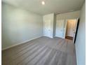 A carpeted bedroom with light gray walls, featuring a closet and an ensuite bathroom at 2371 Brown Dove Way Lot 4, Grayson, GA 30017