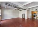 Spacious living area featuring red floors, exposed ductwork, and an open floor plan leading to the kitchen at 806 Marcus Se St # 21, Atlanta, GA 30316
