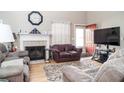 Cozy living room featuring a fireplace, mantle, and large windows, creating a comfortable and inviting space at 11 Montclair Ct, Cartersville, GA 30121