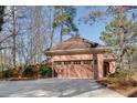 Spacious two-car garage with wooden doors and a paved driveway at 1865 Berkeley Mews Ne, Atlanta, GA 30329