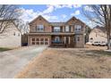 Charming two-story brick home with a welcoming front porch and well-maintained front yard on a sunny day at 6124 Locklear Way, Douglasville, GA 30134