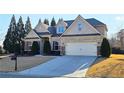 Beautiful brick home with manicured landscaping, two-car garage, and a welcoming entrance at 6515 Bentley Ridge Dr, Cumming, GA 30040