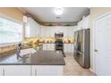 Modern kitchen featuring granite countertops, stainless steel appliances, and white cabinets at 2678 Neighborhood S Walk, Villa Rica, GA 30180