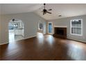 Bright living room featuring hardwood floors, fireplace, and vaulted ceilings at 3151 Victoria Place Dr, Loganville, GA 30052