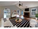 Staged living room with fireplace, hardwood floors, and an abundance of natural light at 3151 Victoria Place Dr, Loganville, GA 30052