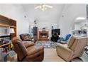 Cozy living room with a brick fireplace, comfortable seating, and an open view into the kitchen at 40 Berkshire Run, Covington, GA 30016