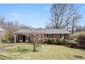 Quaint one-story brick house features a tidy front lawn and classic architectural details at 1523 Delia Dr, Decatur, GA 30033