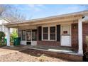 Close-up of a home's front porch featuring a screen door, brick facade, and well-worn entryway at 1523 Delia Dr, Decatur, GA 30033