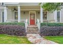 Inviting front porch with stone steps, lovely landscaping, and a welcoming red front door at 1624 Duncan Nw Dr, Atlanta, GA 30318