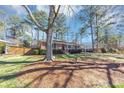 Serene landscape with mature trees frames this charming brick home with well-kept grass and natural pine straw accents at 2187 Freydale Se Rd, Marietta, GA 30067