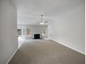 Bright living room featuring fireplace, neutral walls and plush carpet at 351 Beckenham Ln, Dacula, GA 30019