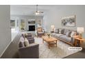 Bright living room featuring fireplace, neutral walls and plush carpet at 351 Beckenham Ln, Dacula, GA 30019