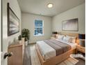 Staged bedroom with a neutral color palette, soft lighting, and a view of the outdoors at 6077 Oakley Rd, Union City, GA 30291