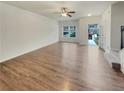 Bright living room featuring a ceiling fan, neutral walls, and wood-look flooring at 6077 Oakley Rd, Union City, GA 30291