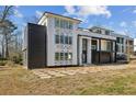 Side view of a modern home featuring a black brick accent wall and a geometric paved driveway at 1410 Lavista Ne Rd, Atlanta, GA 30324