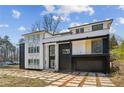 Contemporary home showcasing a modern design with a dark brick garage and geometric concrete driveway at 1410 Lavista Ne Rd, Atlanta, GA 30324