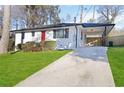 Ranch-style home with a white exterior, red door, and attached carport at 1796 Arkose Se Dr, Atlanta, GA 30316