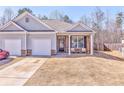 Townhome with an attached one-car garage, front porch and manicured lawn at 530 Vandenburg Dr, Villa Rica, GA 30180