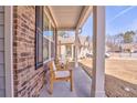 Inviting front porch featuring seating, exposed brick, and great natural light at 530 Vandenburg Dr, Villa Rica, GA 30180