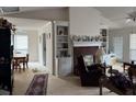 Bright living room with a cozy fireplace and built-in shelving at 2690 Freemans Walk Dr, Dacula, GA 30019