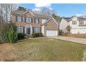 Charming two-story brick home featuring a two-car garage and manicured lawn at 4002 Forest Grove Nw Pass, Acworth, GA 30101