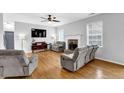 Bright living room with fireplace, hardwood floors, and ample seating at 4002 Forest Grove Nw Pass, Acworth, GA 30101