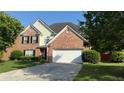 Beautiful two-story home with brick facade, black shutters, attached two-car garage, and well-maintained lawn at 480 Glenns Farm Way, Grayson, GA 30017