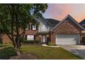 Charming two-story brick home with well-manicured lawn and attached two-car garage at 480 Glenns Farm Way, Grayson, GA 30017