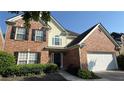 Brick home with classic architectural details, well-manicured landscaping, and an attached two-car garage at 480 Glenns Farm Way, Grayson, GA 30017