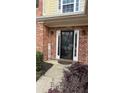 Close-up of the front door with a glass insert and sidelights, set in a brick facade and lovely landscaping at 480 Glenns Farm Way, Grayson, GA 30017