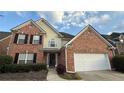 Charming two-story brick home with attached two-car garage, black shutters, and manicured landscaping at 480 Glenns Farm Way, Grayson, GA 30017