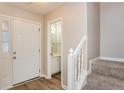 Inviting entryway with wood-look floors, white trim, and a convenient half bathroom off to the side at 4893 Autumn Cir, Stone Mountain, GA 30088
