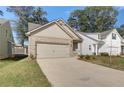 Inviting beige brick home with a two-car garage, professionally landscaped yard, and cozy front entryway at 2208 Croghan Dr, Hampton, GA 30228