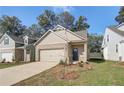 Inviting beige brick home with a two-car garage, professionally landscaped yard, and cozy front entryway at 2208 Croghan Dr, Hampton, GA 30228