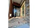 Elegant entryway showcasing a detailed wrought iron front door and stone accents at 3499 Lake Mill Rd, Buford, GA 30519