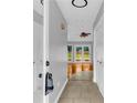 Hallway with tile flooring leading to a living area with hardwood flooring and a view of the backyard at 221 The Esplanade Se Way, Loganville, GA 30052