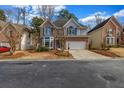 Attractive home featuring brick and gray siding, a two-car garage, and a nicely maintained lawn at 3369 Arbor Path Dr, Atlanta, GA 30340